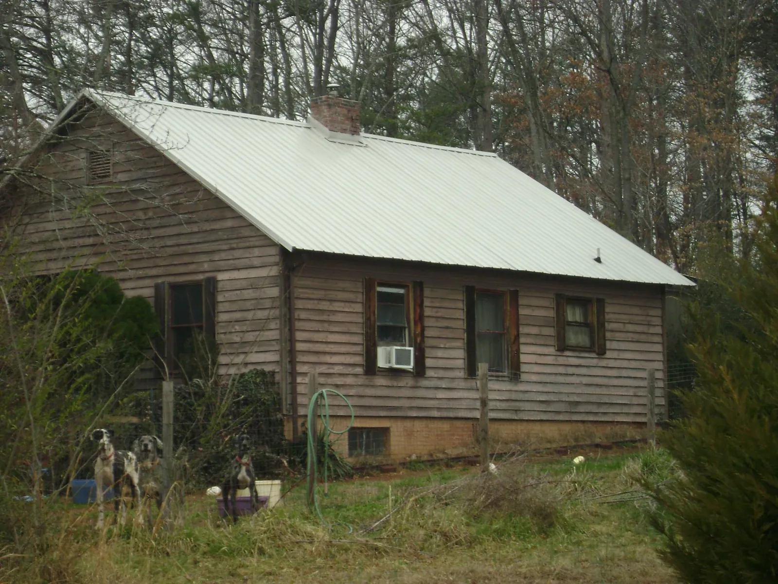 White metal roof on an old wood sided farmhouse, from a Metal Roof Installation job in Altona